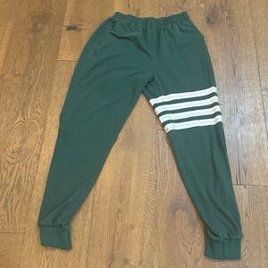 Green Adidas Adicolor Joggers with three white stripes